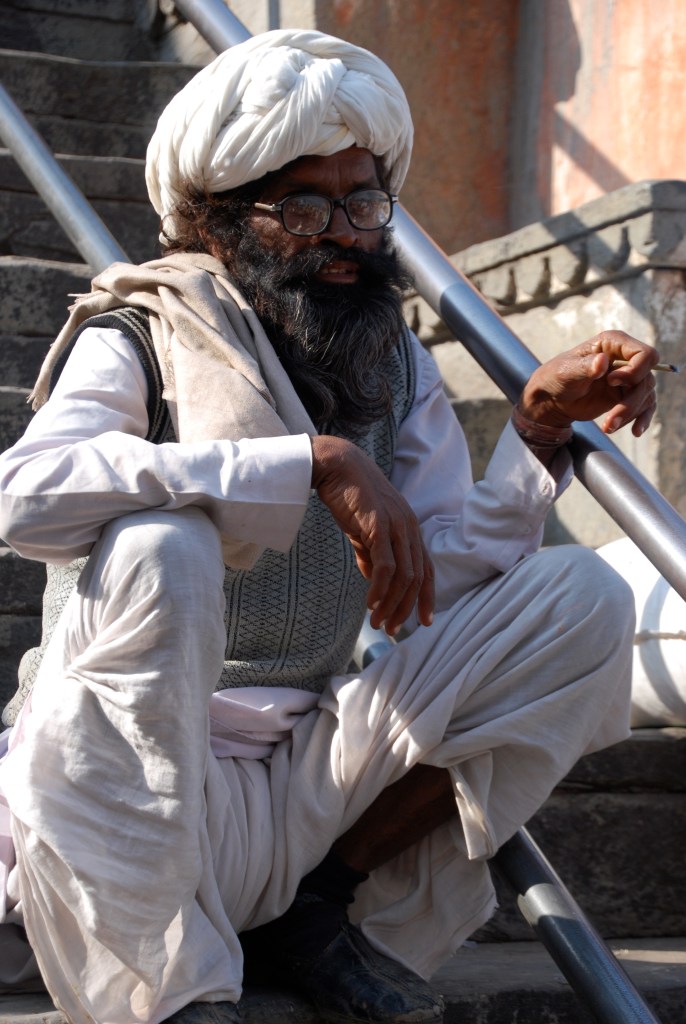 This gentleman is sitting on the steps of a Hindu temple smoking a cigarette. We were told he is a priest at the temple.