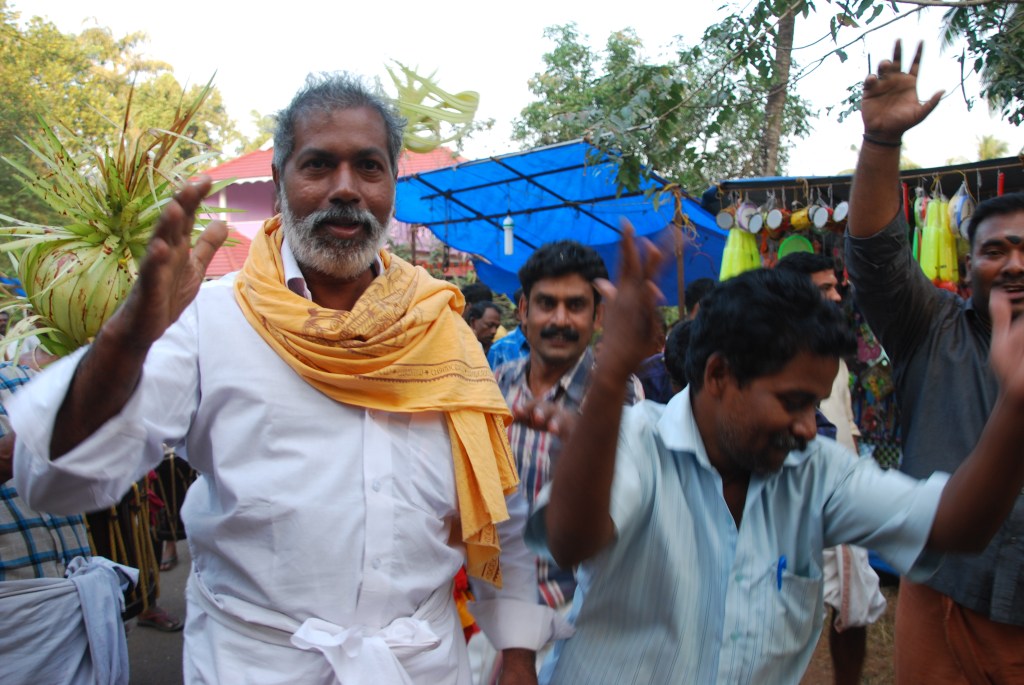 Men enjoying the festival, happy to pose for photos.