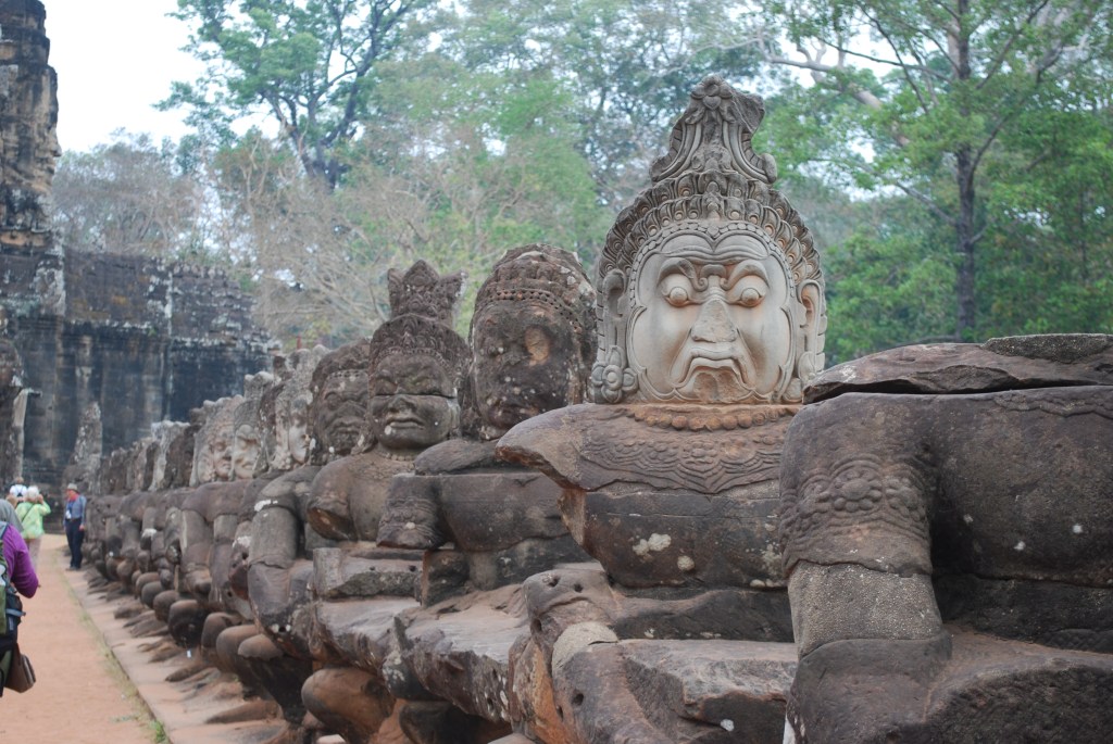 Faces on bridge over moat at Angkor Thom