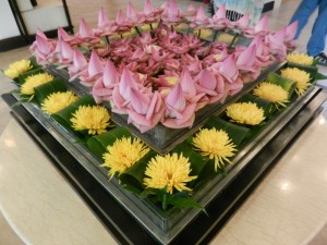 Tray of lotus blossoms in hotel lobby
