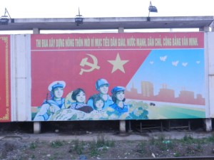 The hammer and sickle flag is the Communist Party flag. The other flag with the star is the Vietnam flag.