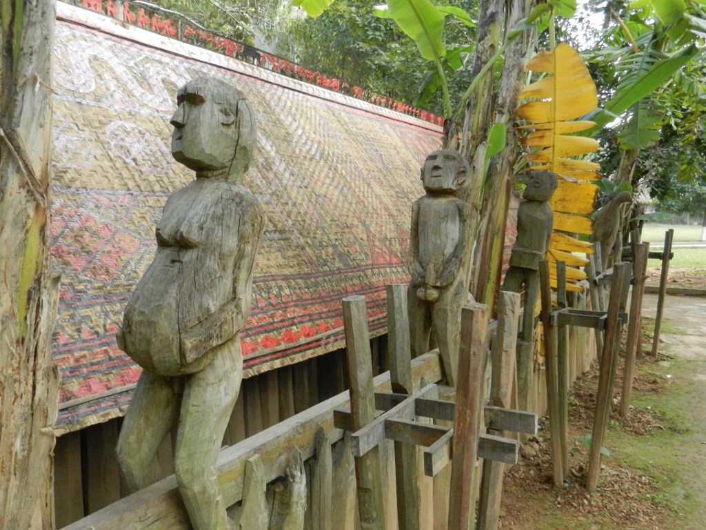 The carved figures are showing each other in quite graphic details their private parts. They are symbols of fertility to counter the death. This figure at the corner doesn't seem too happy with the whole thing.