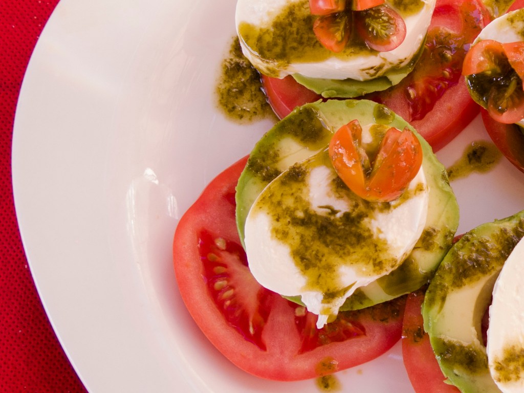 A salad of tomatoes, avocados and bocconcini